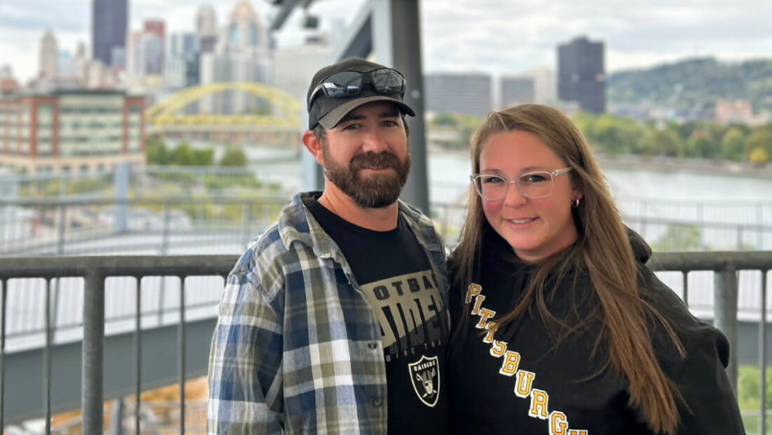 Olivia Gray with her husband in front of a city scape