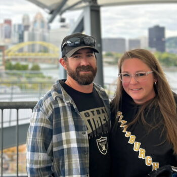 Olivia Gray with her husband in front of a city scape
