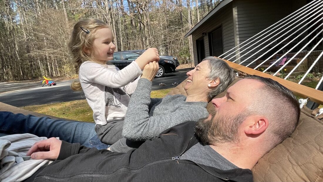 Brett Moffitt with wife and daughter enjoying a nice autumn day on a hammock