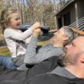 Brett Moffitt with wife and daughter enjoying a nice autumn day on a hammock