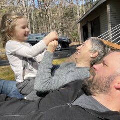 Brett Moffitt with wife and daughter enjoying a nice autumn day on a hammock